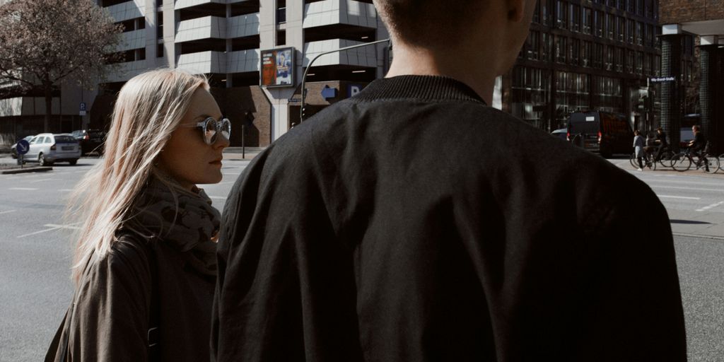 man and woman looking at the street during daytime