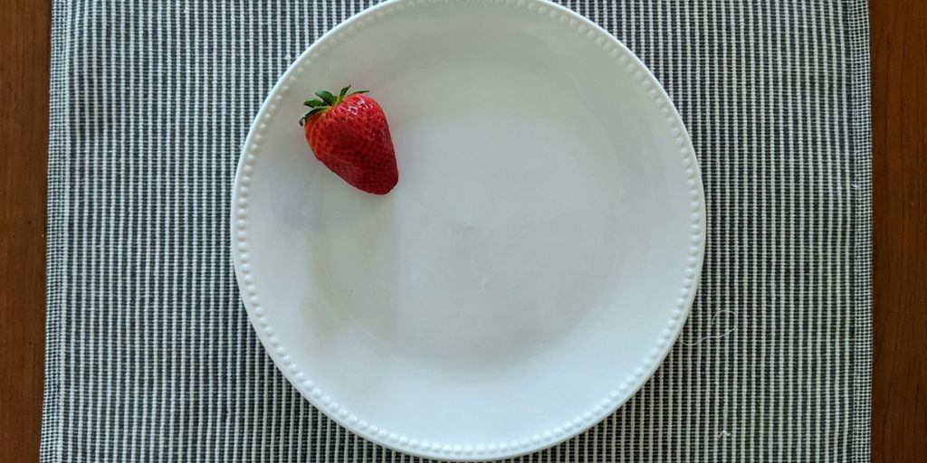 red strawberry on white ceramic plate