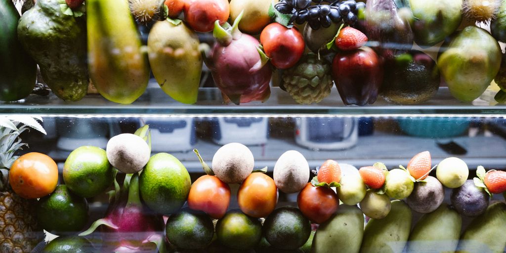 A display case filled with lots of different types of fruit