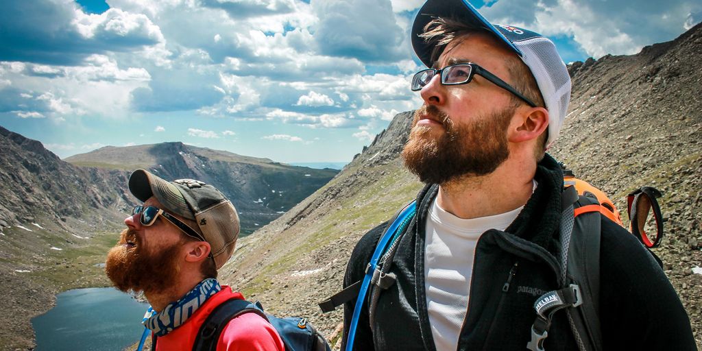 two male hikers looking up at the sky
