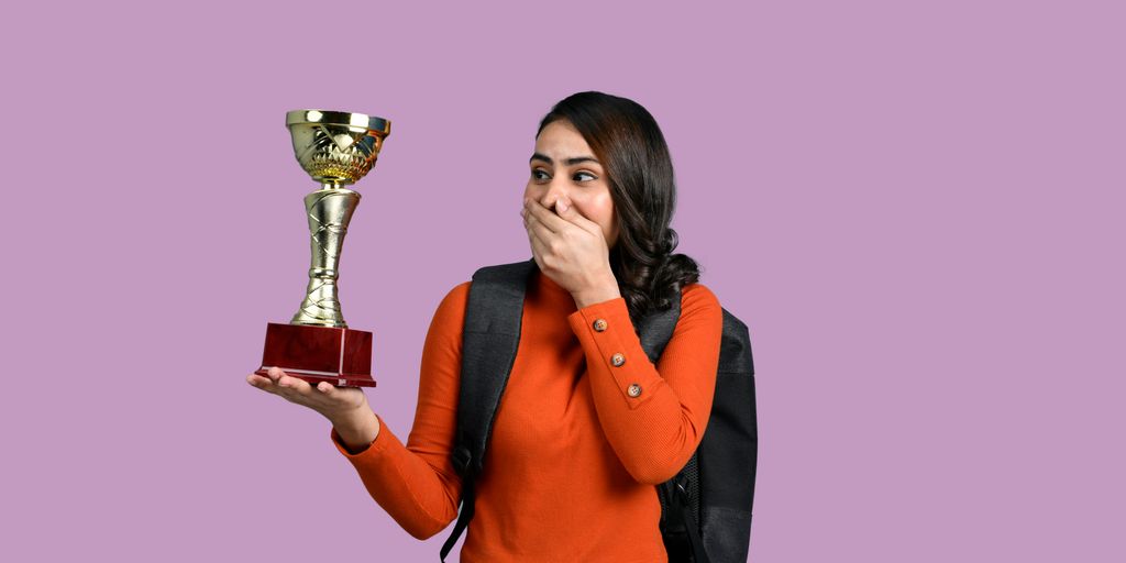 a woman holding a trophy
