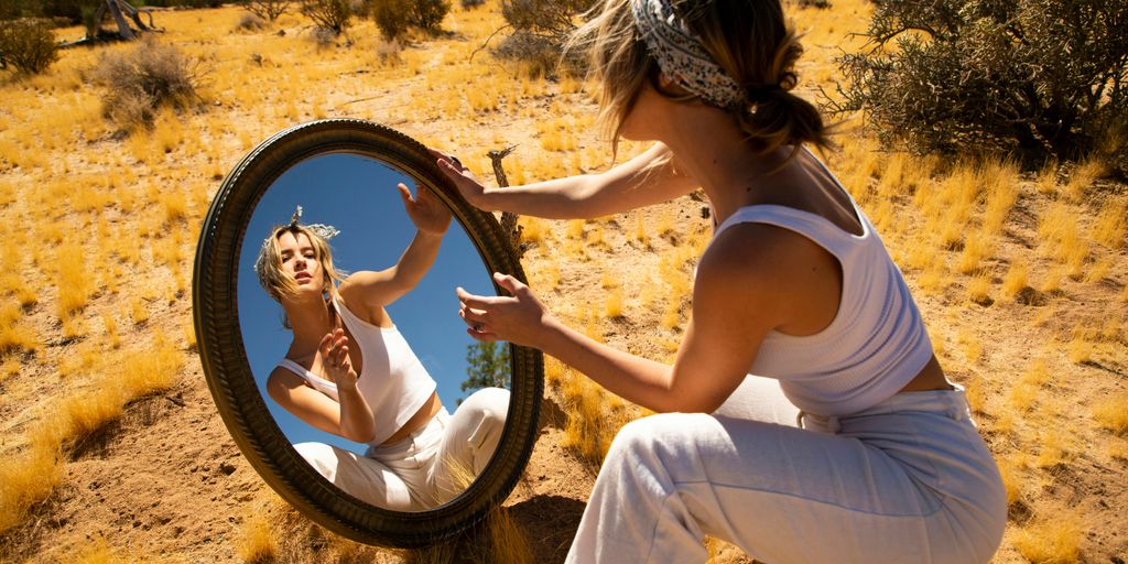 woman in white with a mirror