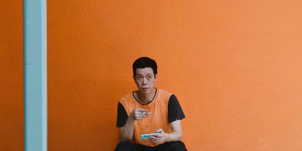 a man sitting on a step holding a cell phone