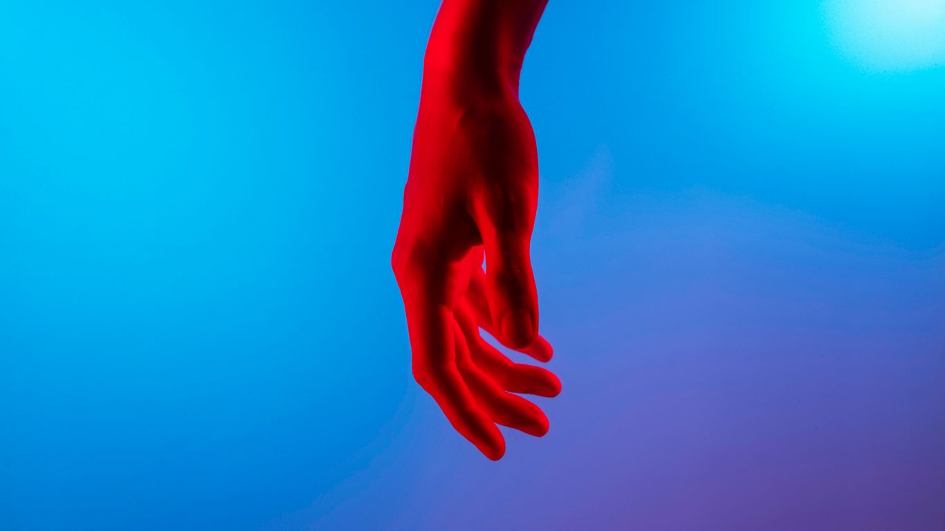 persons left hand on blue surface