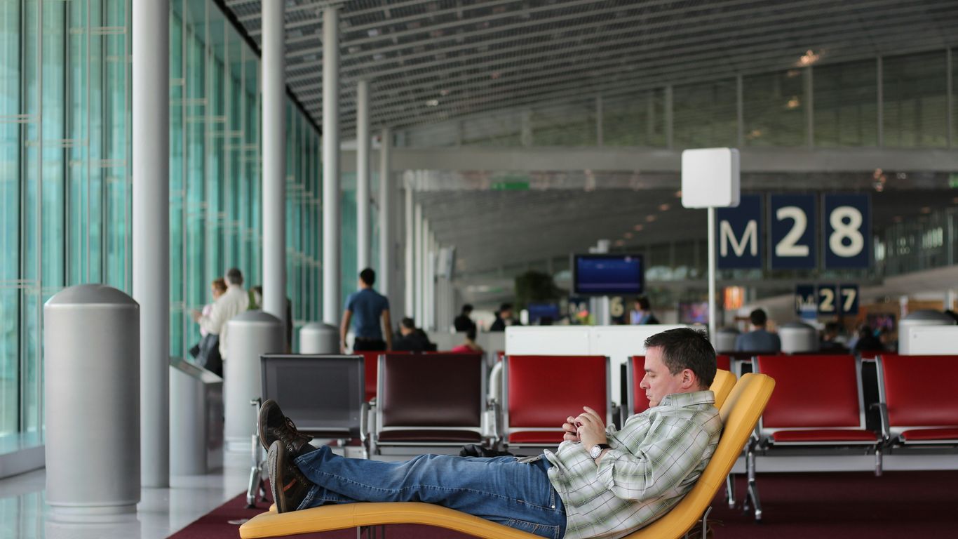 man sitting on airport waiting area