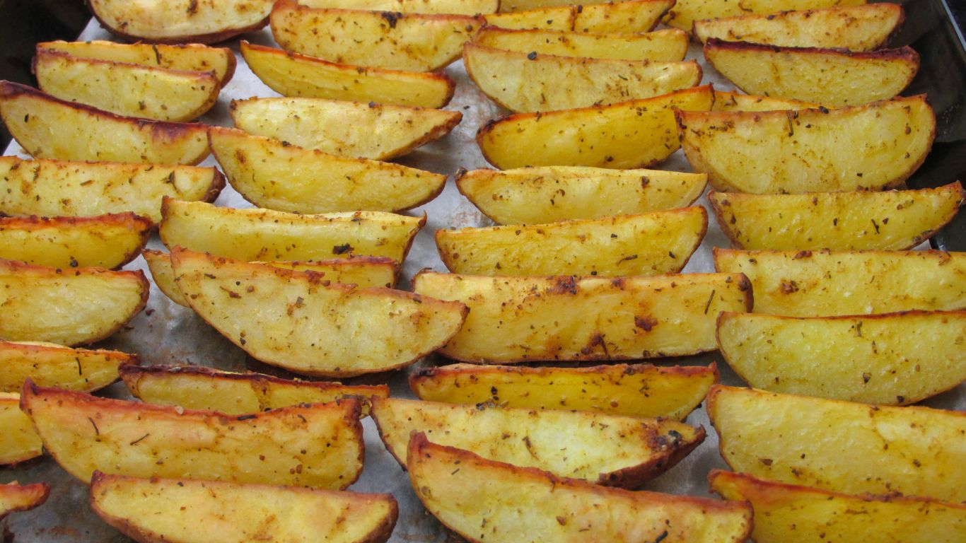a pan filled with cooked potatoes on top of a table