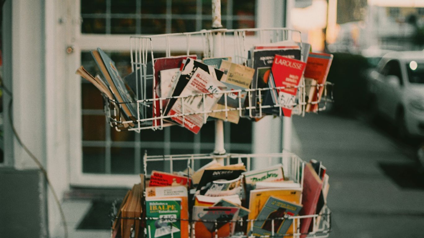 a shopping cart filled with lots of books