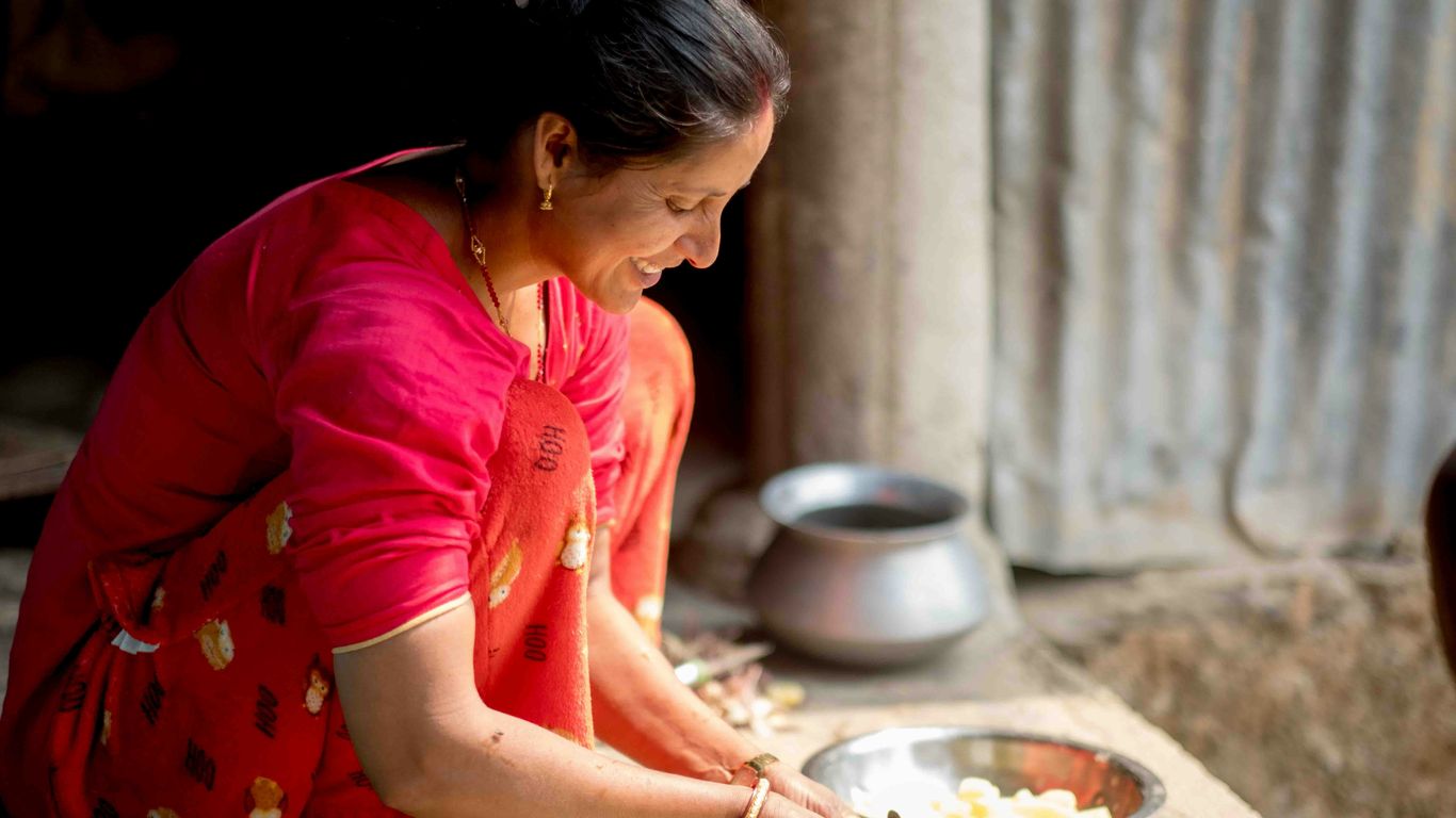 a woman in a red shirt is preparing food