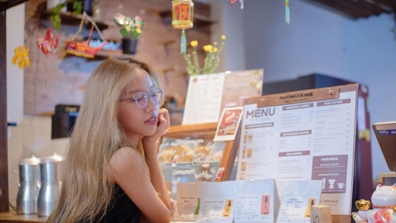 A little girl sitting at a counter in a restaurant