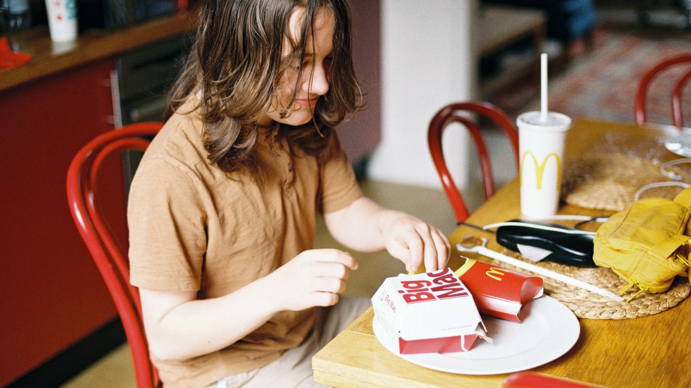 a woman cutting a cake