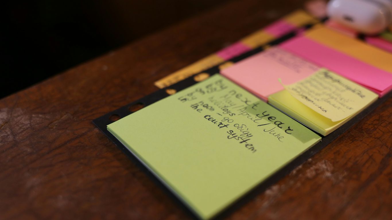 green sticky note on brown surface