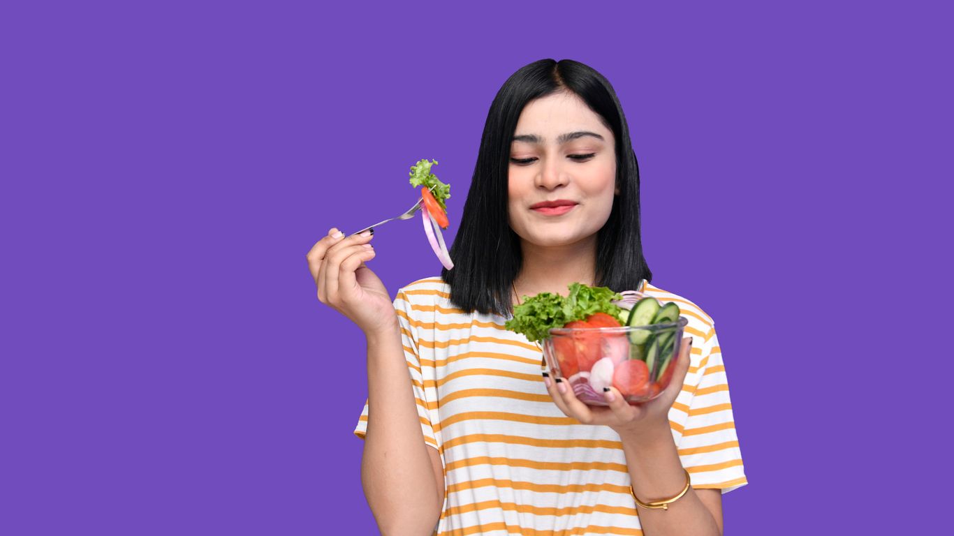 a woman holding a bowl of fruit