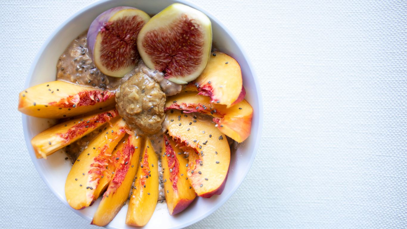 a white bowl filled with sliced fruit on top of a table