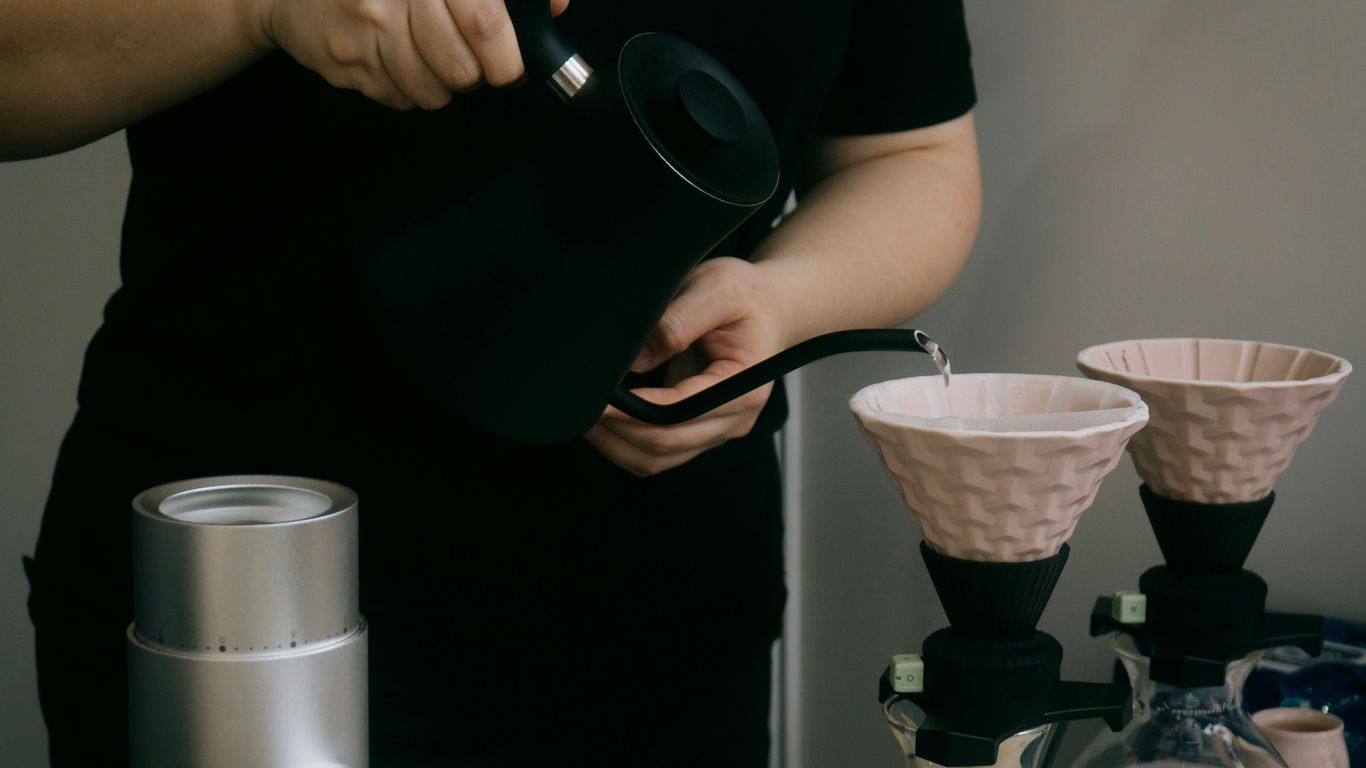 Someone is pouring water over coffee grounds.