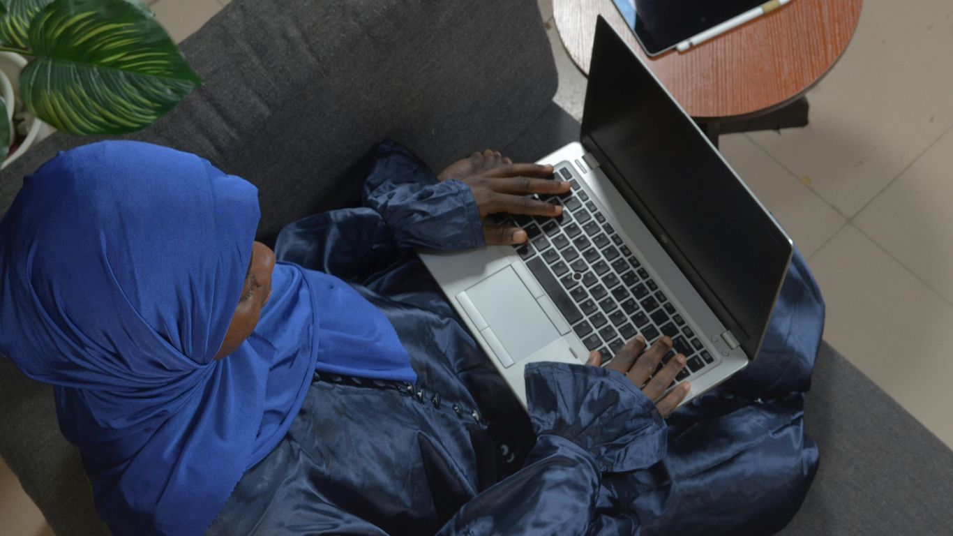 a person lying on the couch with a laptop