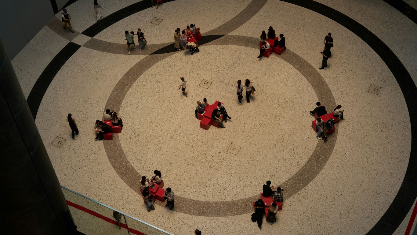A group of people walking around a building