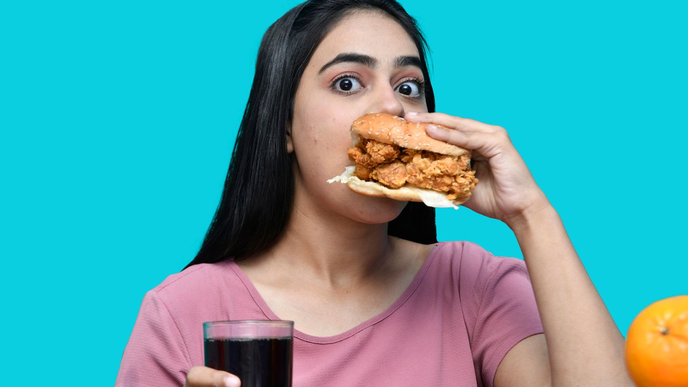 a woman eating a sandwich