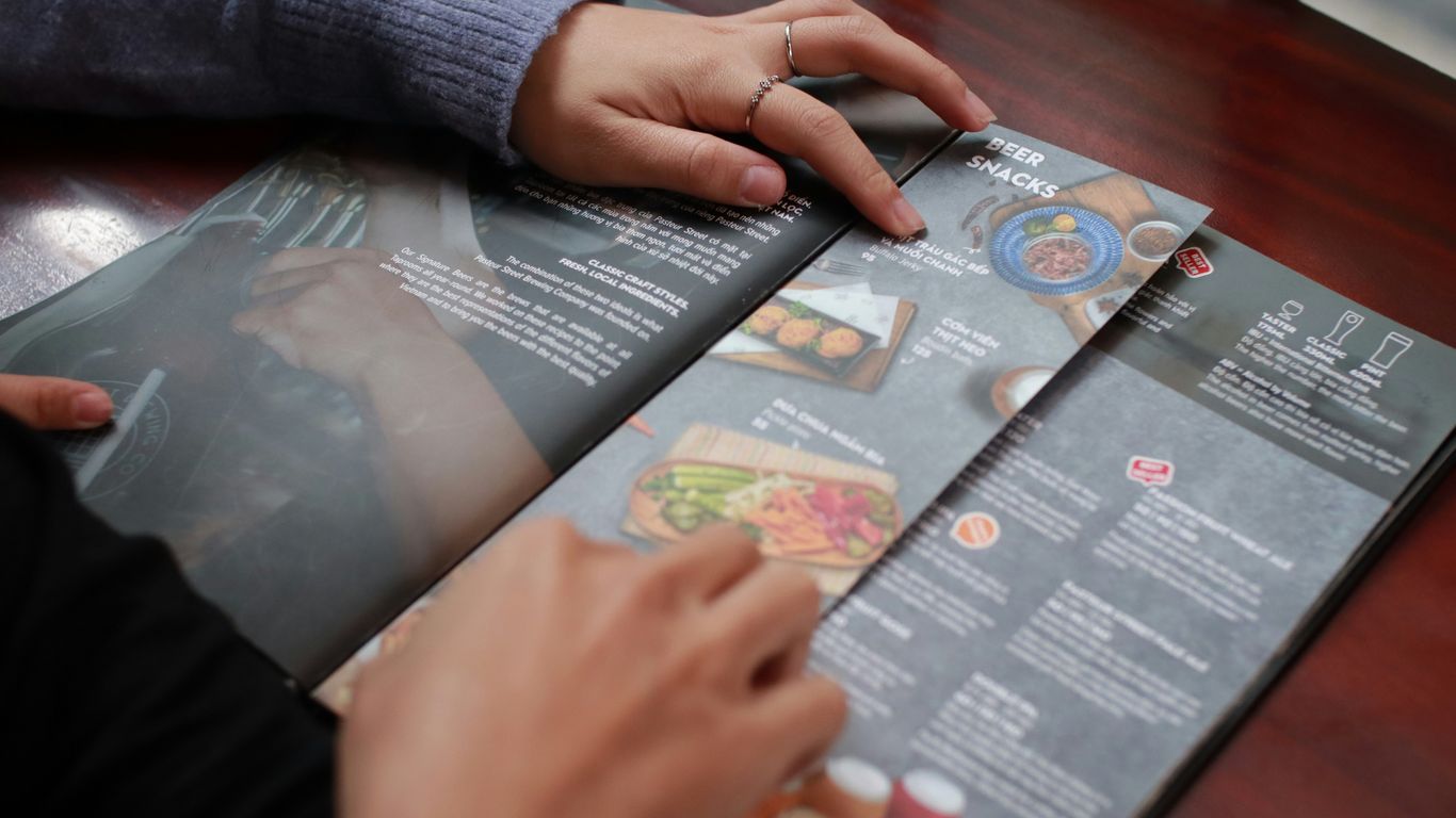 person holding white and black labeled box