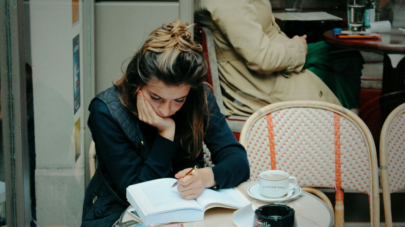 woman in black jacket sitting on chair