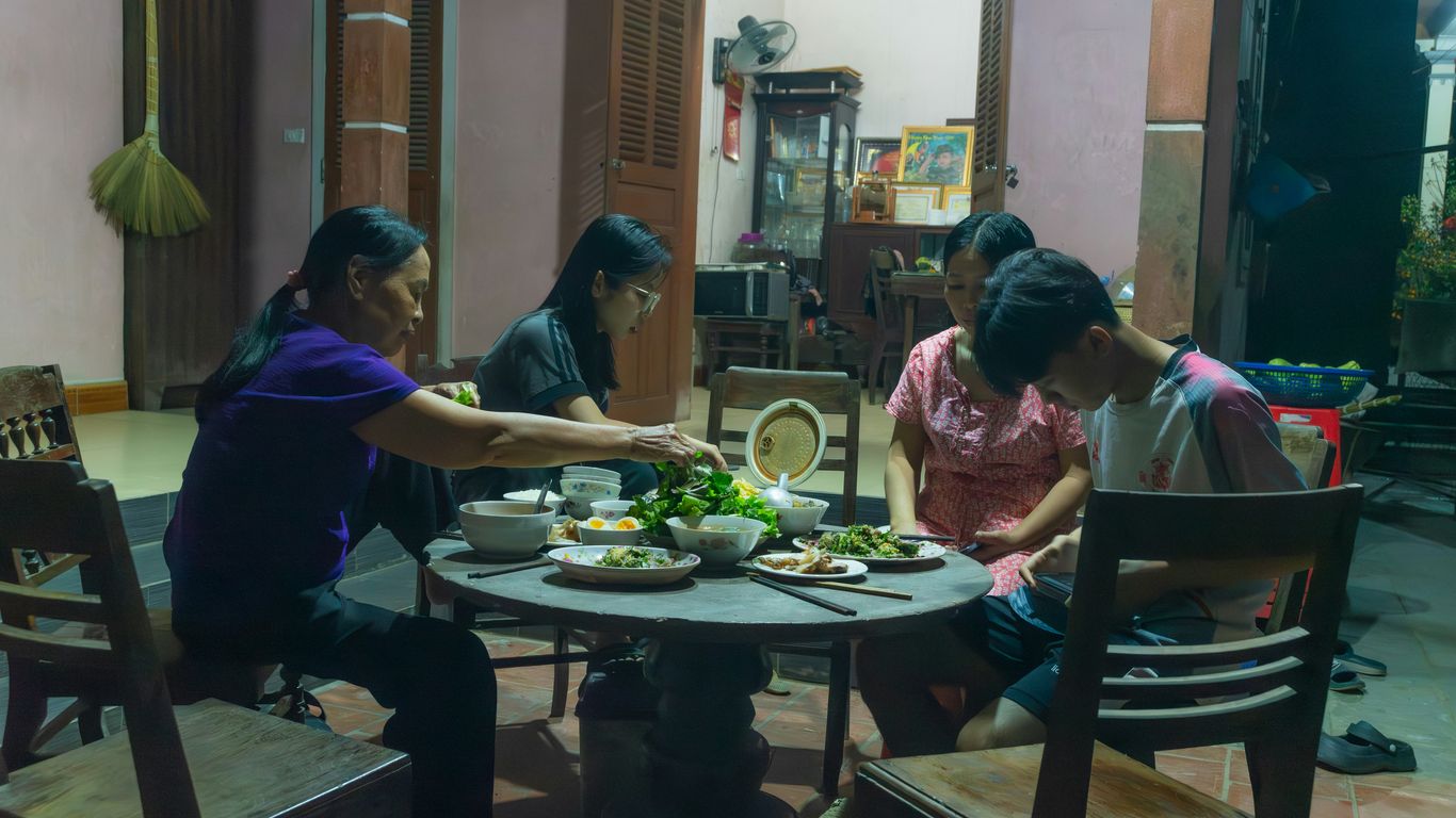 a group of people sitting around a table eating food