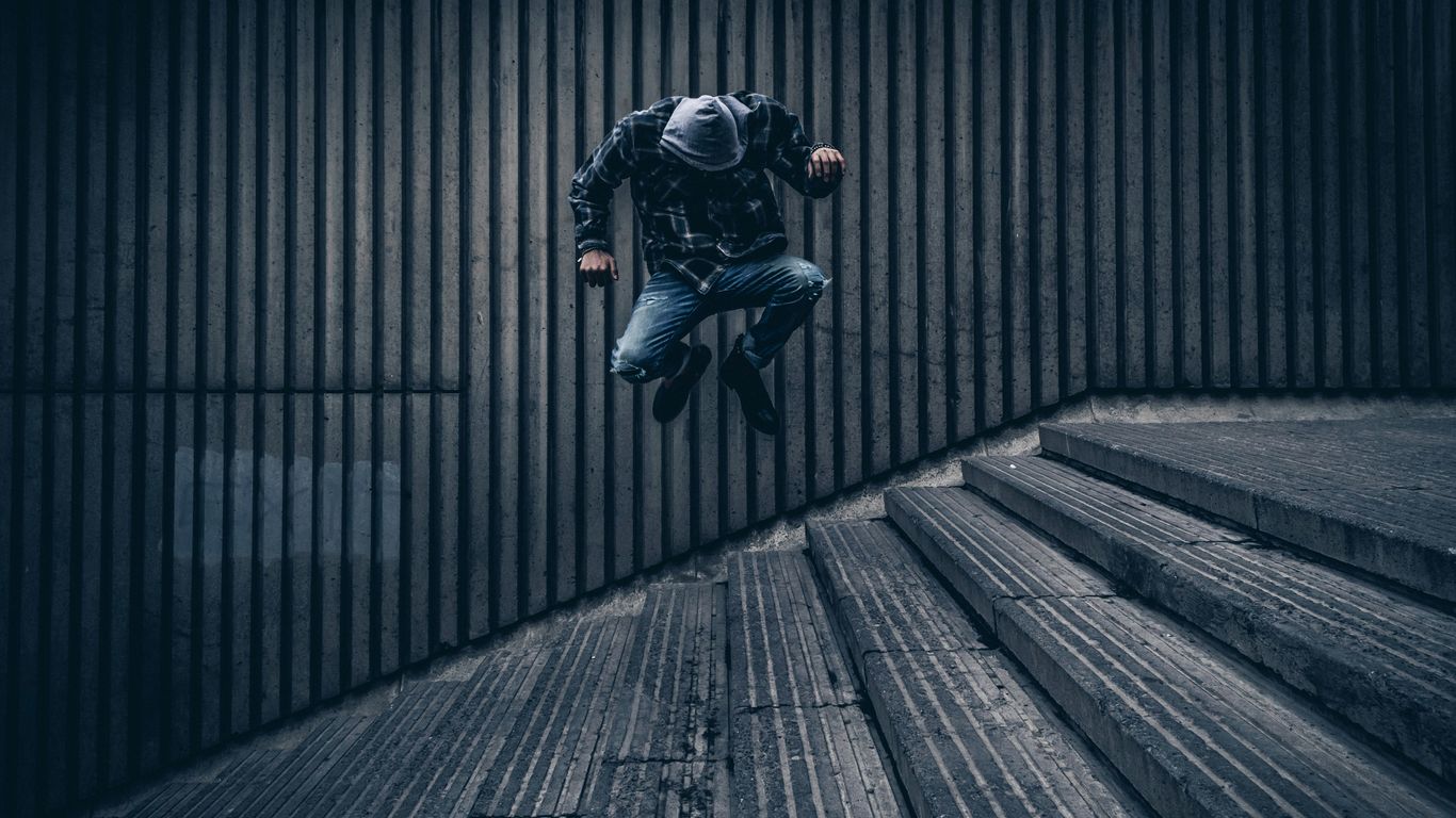 time-lapse photography of man jumping over staircase